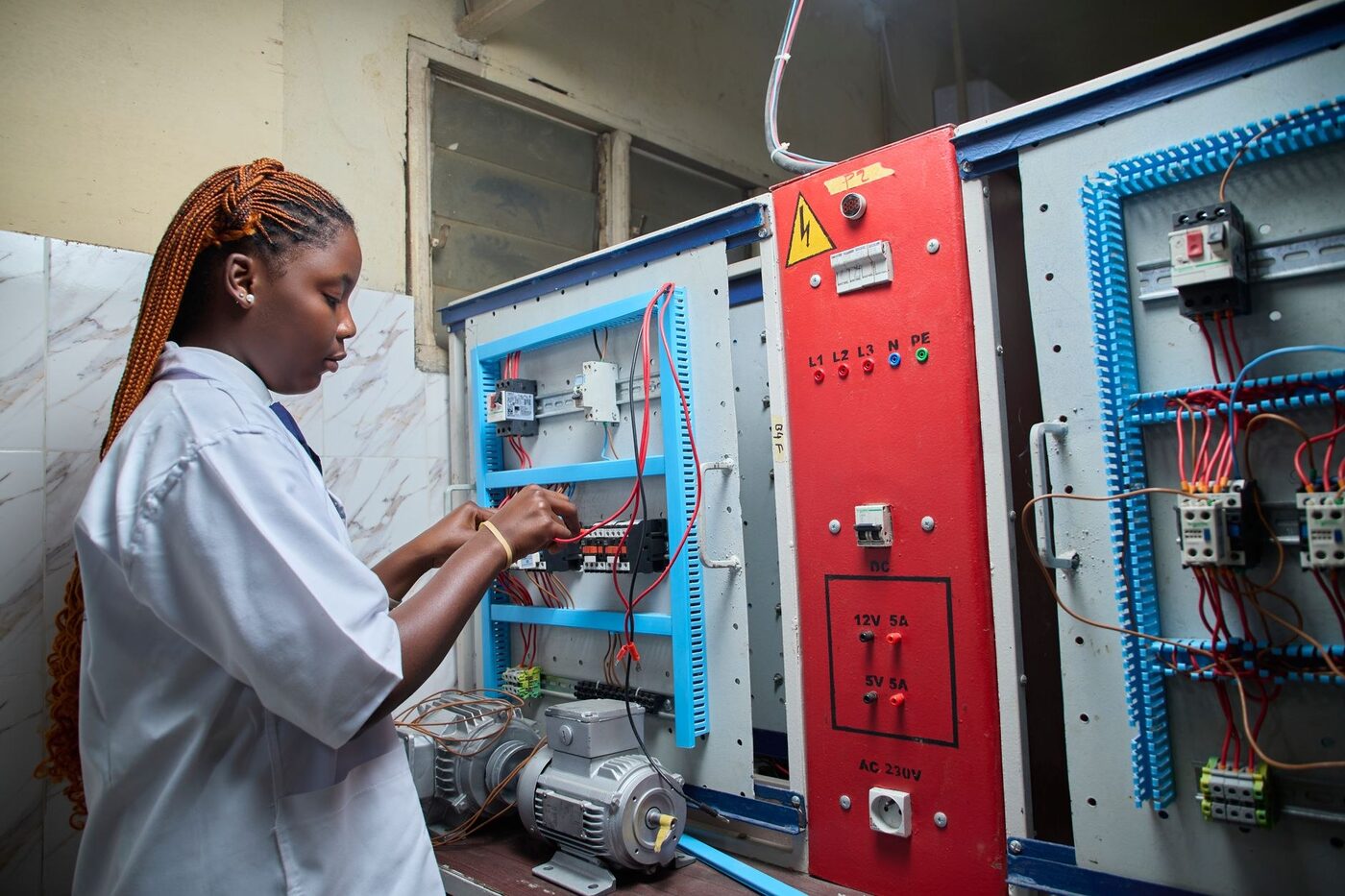 Electrician testing a control panel